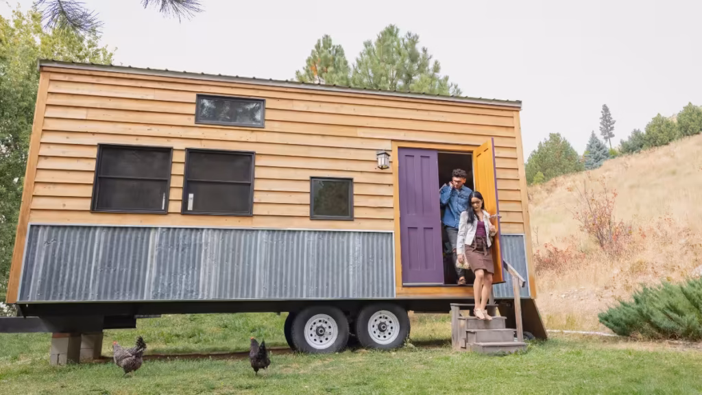 Tiny home on wheels parked in a forest setting, illustrating why are tiny homes not a good idea for every lifestyle
